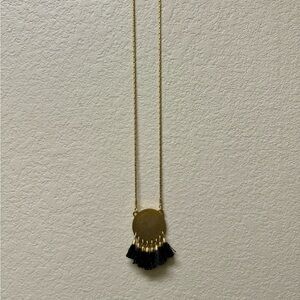 Brass like with black yarn tassels necklace.